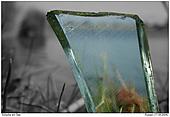 Piece of broken glas in the nature - Piece of broken glas in front a sea